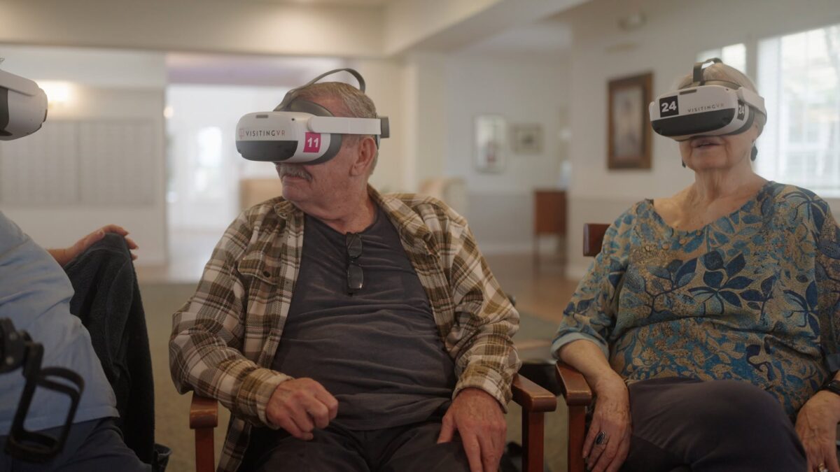 Two residents of a senior living community watching a VR experience together