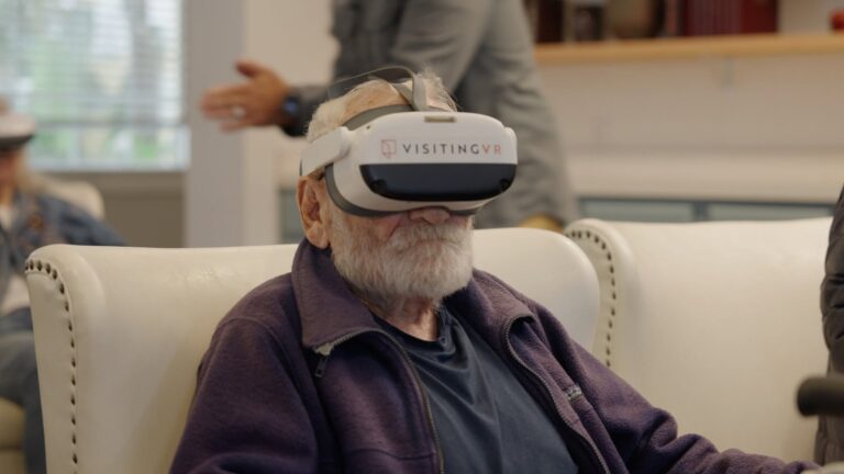 A resident wearing a VR headset during a Visiting VR session